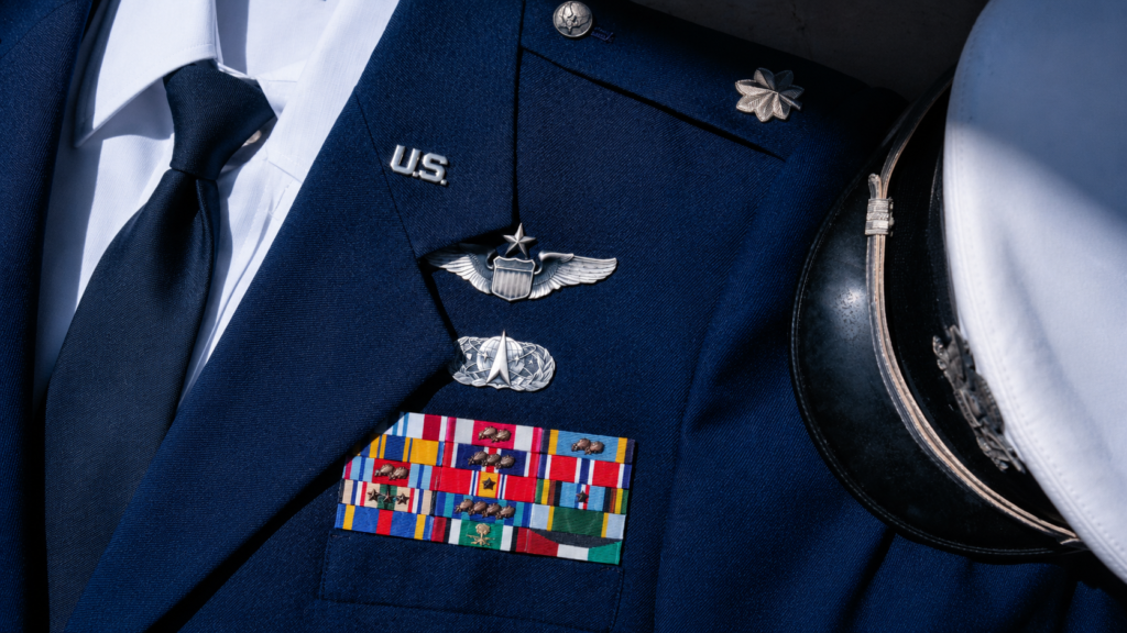 Current image: U.S. Space Force service dress uniform displaying military ribbons, badges, and insignia on a blue jacket