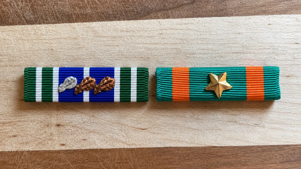 Oak leaf cluster and 5 16 inch star on achievement medal ribbons compared