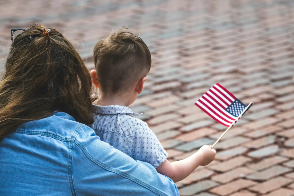Child holding an American flag at a Veterans Day event